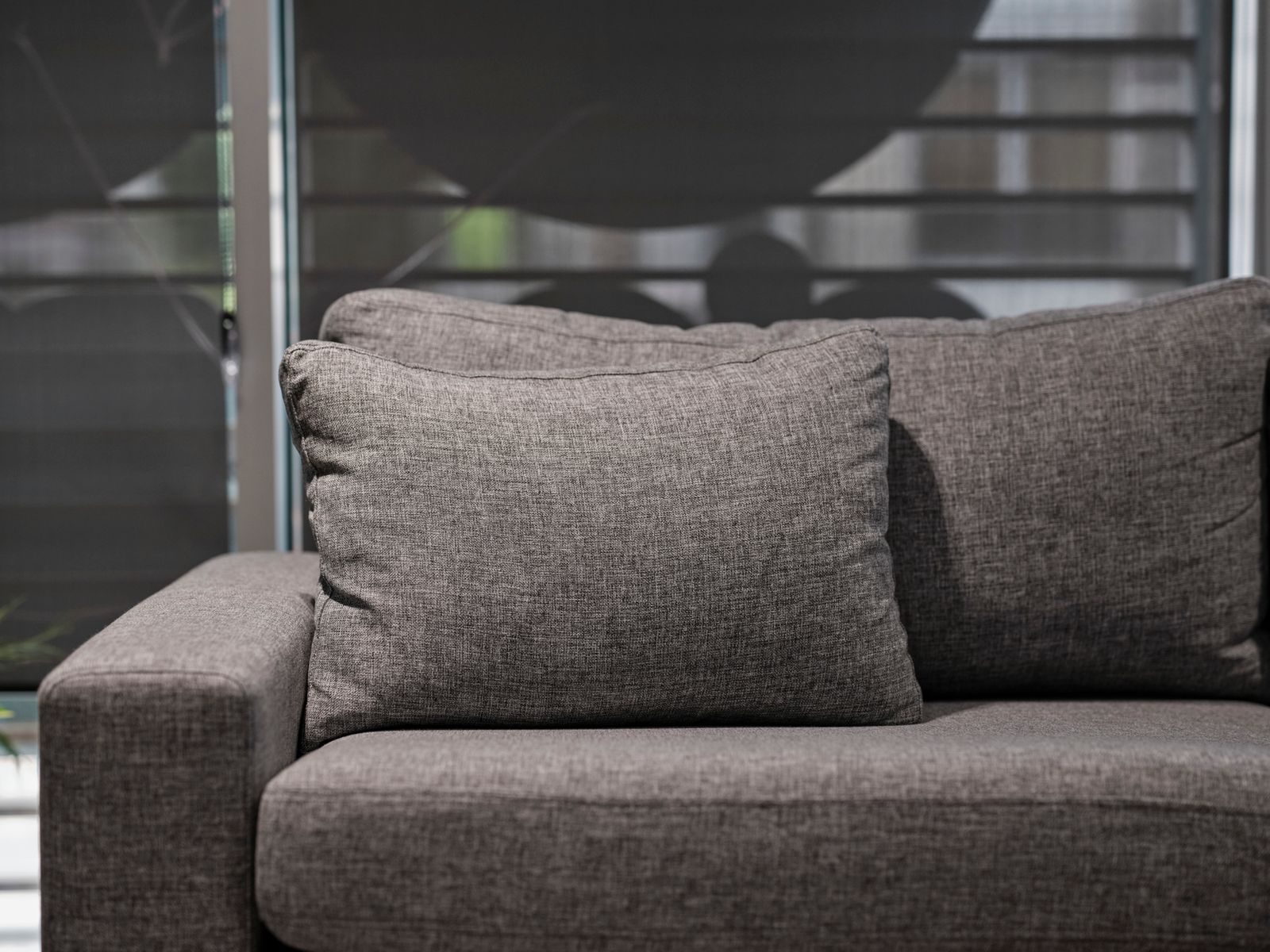 A freshly cleaned grey fabric sofa